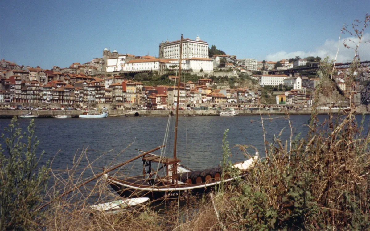 A rabelo boat on the Douro below the Ribeira houses, seen on a port wine cellar tour in Vila Nova de Gaia